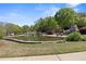Ground-level view of a peaceful community pond with natural stone edging and a fireplace at 1338 Dupont Nw Park, Atlanta, GA 30318