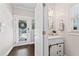 Bright powder room boasts a modern vanity, decorative mirror, and stylish barn door storage at 1338 Dupont Nw Park, Atlanta, GA 30318