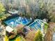 Serene aerial view of community pool and tennis courts nestled among lush greenery and mature trees at 2580 Hyde Manor Dr, Atlanta, GA 30327