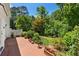Backyard features a brick patio, lush landscaping, and a charming garden area at 2580 Hyde Manor Dr, Atlanta, GA 30327