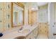 Stylish bathroom with double sinks, decorative wallpaper, and a window with shutters at 2580 Hyde Manor Dr, Atlanta, GA 30327