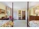 Bright bedroom featuring two four-poster beds, complemented by floral drapery and art at 2580 Hyde Manor Dr, Atlanta, GA 30327