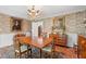 Charming dining room features decorative wallpaper, wood floors, chandelier and table at 2580 Hyde Manor Dr, Atlanta, GA 30327