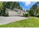 Spacious home exterior with a large driveway, two-car garage, and well-maintained lawn at 2580 Hyde Manor Dr, Atlanta, GA 30327
