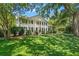 Colonial-style home with white exterior, black shutters, and a well-manicured front yard at 2580 Hyde Manor Dr, Atlanta, GA 30327
