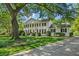 Stately white home featuring classic columns, manicured landscaping, and mature trees at 2580 Hyde Manor Dr, Atlanta, GA 30327