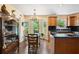 Eat-in kitchen featuring hardwood floors, black counters, and bay windows that bring in natural light at 2580 Hyde Manor Dr, Atlanta, GA 30327