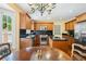 Kitchen featuring stainless steel appliances, black counters, wooden cabinets and hardwood floors at 2580 Hyde Manor Dr, Atlanta, GA 30327