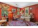Cozy living room featuring red walls, floral accents, and comfortable seating at 2580 Hyde Manor Dr, Atlanta, GA 30327