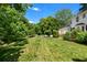 Spacious, grassy yard with mature trees, and part of the home is visible at 2580 Hyde Manor Dr, Atlanta, GA 30327