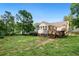 Expansive backyard with lush greenery and a wooden deck, perfect for outdoor activities at 39 Cannon Pl, Dallas, GA 30157