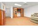 This finished basement features a large TV with built-in cabinets and neutral carpet at 39 Cannon Pl, Dallas, GA 30157