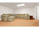 The finished basement offers a large sectional sofa with comfortable seating and neutral carpet at 39 Cannon Pl, Dallas, GA 30157