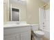 This bathroom includes a white sink with cabinets, toilet, and shower with white tile surround at 39 Cannon Pl, Dallas, GA 30157