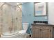 This renovated bathroom features a glass shower, granite sink, and updated fixtures at 39 Cannon Pl, Dallas, GA 30157