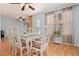 Charming dining room boasts a glass table set, wood floors, and natural light streaming through the window at 39 Cannon Pl, Dallas, GA 30157