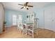 Bright dining room features a glass table set, light blue walls, and a ceiling fan for comfortable dining at 39 Cannon Pl, Dallas, GA 30157