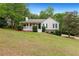 Charming single-story home with a cozy front porch and well-maintained lawn, offering a welcoming curb appeal at 39 Cannon Pl, Dallas, GA 30157