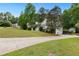 Charming home with a well-manicured lawn, mature trees, and an inviting driveway leading to a three-car garage at 39 Cannon Pl, Dallas, GA 30157