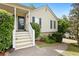 Welcoming front entrance with white stairs, a green door, and lush landscaping at 39 Cannon Pl, Dallas, GA 30157