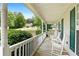 Inviting front porch with rocking chairs, offering a relaxing view of the landscaped front yard at 39 Cannon Pl, Dallas, GA 30157