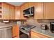 Close-up of the kitchen featuring stainless steel appliances and wooden cabinets, perfect for cooking enthusiasts at 39 Cannon Pl, Dallas, GA 30157
