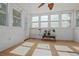 Bright sunroom featuring tile floors, white paneled walls, multiple windows, and ample natural light at 39 Cannon Pl, Dallas, GA 30157