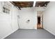 Unfinished basement area with painted floor and walls plus exposed utilities at 6032 Lakeshore Se Dr, Mableton, GA 30126