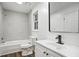 Bright bathroom with white vanity, modern black faucet, tiled shower and wood-look vinyl plank flooring at 6032 Lakeshore Se Dr, Mableton, GA 30126
