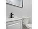 Updated half bathroom with modern vanity, new toilet, and sleek black faucet at 6032 Lakeshore Se Dr, Mableton, GA 30126