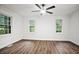 Spacious bedroom with wood-look vinyl plank flooring, fresh neutral paint, and a ceiling fan at 6032 Lakeshore Se Dr, Mableton, GA 30126