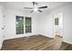 Bright bedroom with ceiling fan, hardwood floors, and a view of the forest at 6032 Lakeshore Se Dr, Mableton, GA 30126