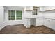 Bright nook featuring white cabinets, marble countertops, and hardwood flooring, perfect for modern living at 6032 Lakeshore Se Dr, Mableton, GA 30126