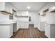 Bright kitchen featuring white cabinets, marble countertops, and hardwood flooring, perfect for modern living at 6032 Lakeshore Se Dr, Mableton, GA 30126