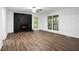 Spacious living room featuring a striking black brick fireplace and hardwood floors, great for gatherings at 6032 Lakeshore Se Dr, Mableton, GA 30126