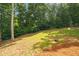 Expansive grassy backyard with mature trees and landscaped border, offering plenty of space and privacy at 7940 Gable Dr, Douglasville, GA 30135