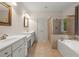 Bathroom with double sinks, soaking tub, and separate shower at 7940 Gable Dr, Douglasville, GA 30135