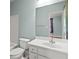Bathroom with tub shower, single vanity, and view into the bedroom at 7940 Gable Dr, Douglasville, GA 30135