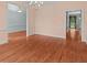 An ample dining area with an elegant chandelier and natural light at 7940 Gable Dr, Douglasville, GA 30135