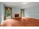 Spacious living room featuring hardwood floors, brick fireplace, and lots of natural light at 7940 Gable Dr, Douglasville, GA 30135