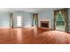 Bright living room with a cozy fireplace, large windows, and access to the backyard at 7940 Gable Dr, Douglasville, GA 30135
