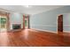 Bright living room boasts hardwood floors, a fireplace, and seamless access to outdoor deck at 7940 Gable Dr, Douglasville, GA 30135