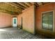 Covered brick patio with concrete floor, perfect for outdoor entertaining or relaxing near the backyard at 7940 Gable Dr, Douglasville, GA 30135