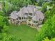 Lush green lawn and covered patios highlight this beautiful estate home at 878 Middle Fork Trl, Suwanee, GA 30024