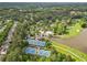 Aerial view of a residential community with pools, tennis courts and a golf course near a lake at 878 Middle Fork Trl, Suwanee, GA 30024