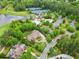 Aerial view showcasing a beautiful home, pool and amenities nestled among lush greenery at 878 Middle Fork Trl, Suwanee, GA 30024