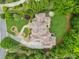 Aerial view of luxury home showcasing intricate roof design and manicured landscaping at 878 Middle Fork Trl, Suwanee, GA 30024