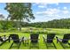 Relaxing backyard view with comfortable chairs overlooking the beautiful scenery at 878 Middle Fork Trl, Suwanee, GA 30024