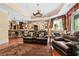 The basement features a wet bar with stone accents, with a leather sofa, chair, and large area rug for entertaining at 878 Middle Fork Trl, Suwanee, GA 30024