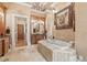 This bathroom features a soaking tub, walk-in shower and detailed finishes at 878 Middle Fork Trl, Suwanee, GA 30024